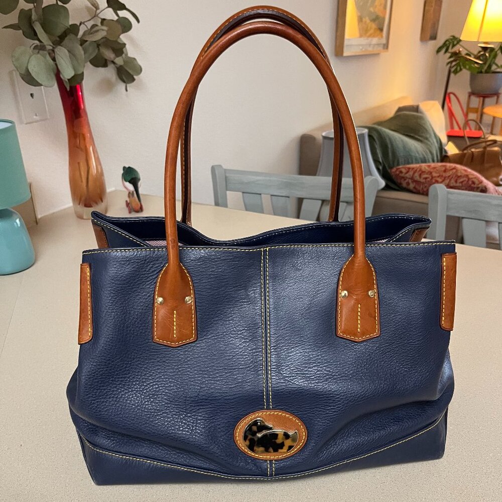 Dooney & Bourke leather satchel.  Navy Blue with Tan handles and trim.